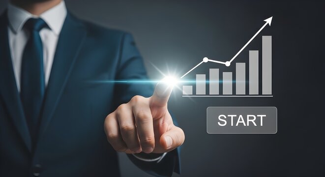 Businessman pointing at a rising stock market graph with the word 'START' indicating the beginning of financial growth and success