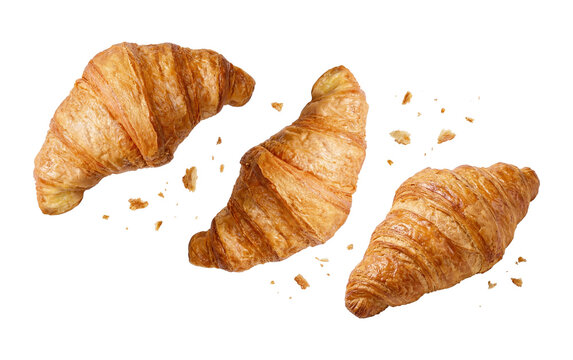 three golden croissants floating in the air with scattered crumbs against a transparent background, creating a dynamic and delicious composition.