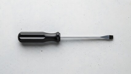 Sleek flathead screwdriver with black handle against textured light gray backdrop