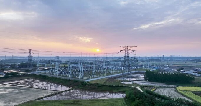 Aerial time-lapse video collection of a large substation, featuring transmission towers, farmland, highways, and clean energy integration into rural grids.
