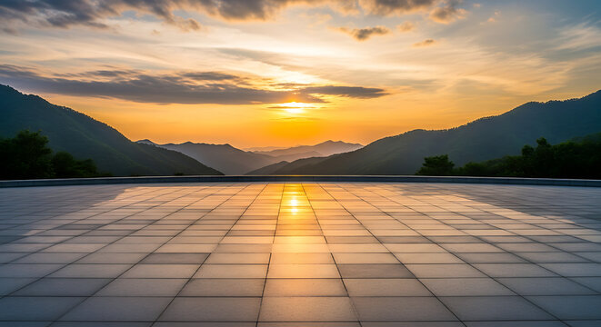 Serene landscape with mountains, trees, and water reflecting a vibrant sunrise or sunset view from a tiled platform perspective