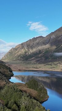 Vertical Aerial View of Serene Lake Moke and Rugged Mountains
