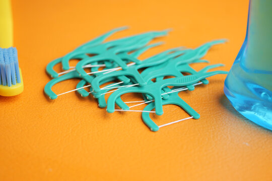 Tips for dental hygiene using floss picks and toothbrush