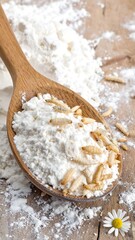 Flour on a wooden spoon with insects, spills over wooden surface next to a small flower