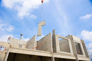Construction Background banner. Large cranes moving prefabricated walls in factories. Prefabricated concrete walls for building office buildings and residential houses. reinforced concrete wall © NVB Stocker