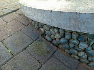 Stone and Concrete Bench Edge on Paved Walkway