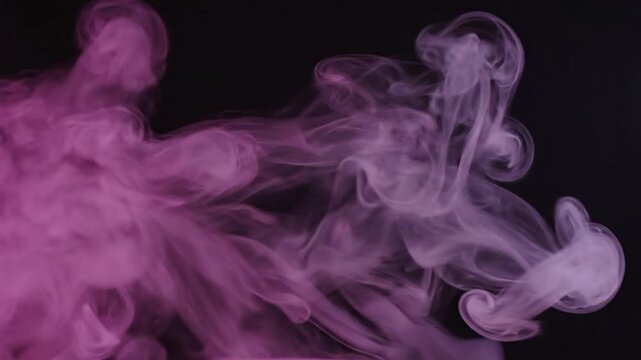 Billowing purple and pink smoke forms an abstract, swirling pattern on a black backdrop