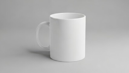 A plain white ceramic mug sits on a plain grey surface, casting a soft shadow.