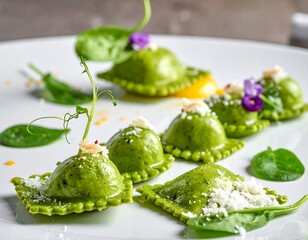 Green ravioli, garnished with spinach, flowers, and cheese, presented on a white plate