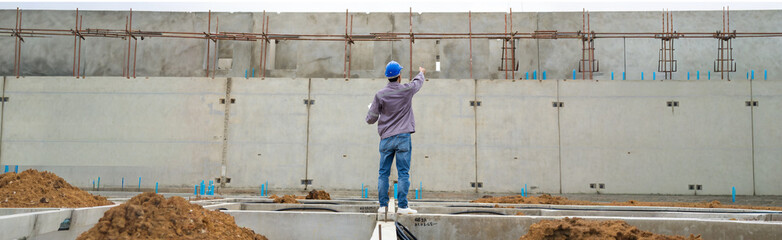 back view Engineering people, construction site. construction worker planning and architecture in construction site. Japanes men