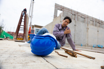 Naklejka premium First Aid safety first and accident concept. Asian japanes Professional Engineering or construction builder worker in safety hard hat helmet lying unconscious at construction site. Civil engineer