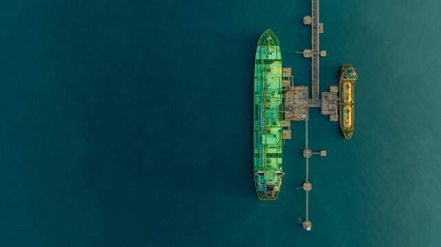 Aerial view LPG tanker ship at oil and gas terminal platform, Liquefied Petroleum Gas tanker ship industrial oil gas terminal tanker ship, LPG tanker ship loading and unloading petrochemical industry.
