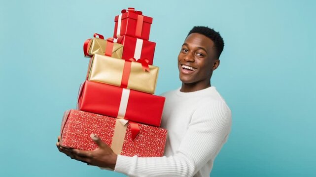 Man holds stack of wrapped gifts