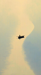 Silhouette of person rowing boat on calm water