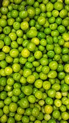 A close-up view of a large group of green peas