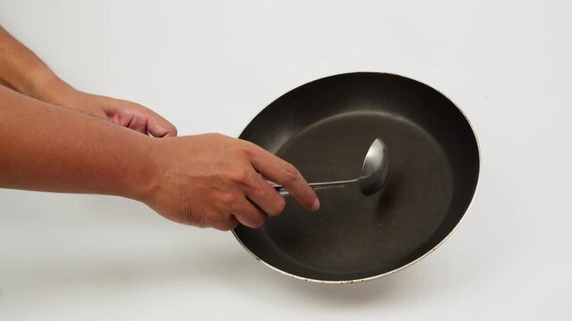 Hitting a Frying Pan with a Large Spoon