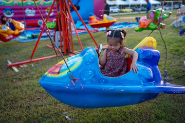 Little girl enjoy outdoor amusement city park festival
