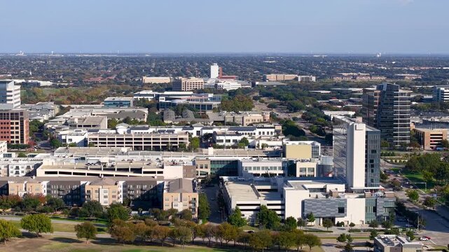 Expansive aerial view of the Plano city in Texas, showing modern buildings, parks, and cityscape.