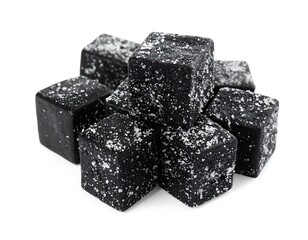 Black, cube-shaped candies dusted with white crystals piled together
