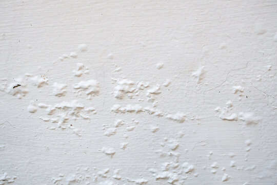 Peeling and Bubbling White Paint on Concrete Wall Texture Background