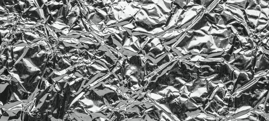 Shiny metal silver gray foil leaf crumpled texture background
