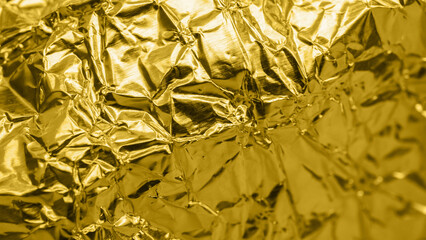 Luxury shiny metallic golden foil crumpled texture background