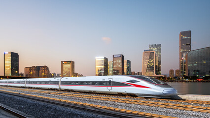 High-Speed Train on Urban Railway Tracks at Dusk