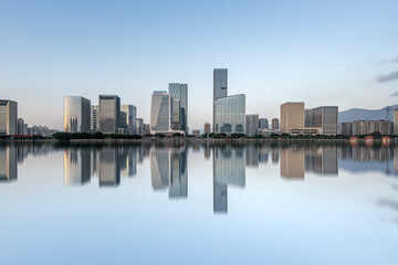 Obraz premium Modern City Skyline with Reflections on Water