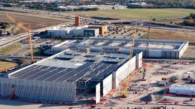 Industrial Data center construction site with cranes erecting a large Industrial building in Texas.