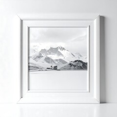 Framed black and white mountain landscape with a snow-covered peak and peaceful lake under a cloudy sky