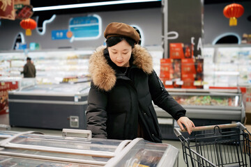 Woman Shopping at Supermarket with Shopping Cart