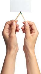 Hands hold matches supporting a white rectangular card, against a white background, viewed in a studio shot