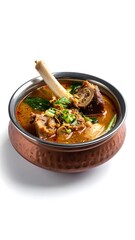 Hearty meaty soup with bones in a hammered copper bowl, garnished with herbs