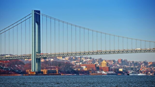 New York, USA, 28 December 2025: Verrazzano Bridge with cargo ships. Verrazzano Narrows Bridge towering above cargo ships in New York Harbor.