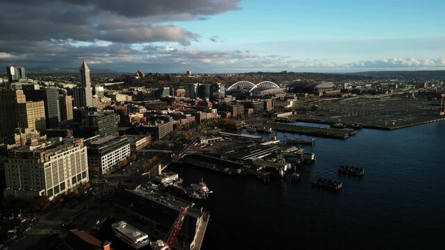 Cinematic Aerial Drone View of Seattle Waterfront and Downtown with Harbor, Stadium District, and Dramatic Clouds
