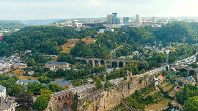 Luxembourg City, Luxembourg. Railway with train. Bridge system. The city is located in a deep valley of two rivers - Alzette and Petrus. Drone footage