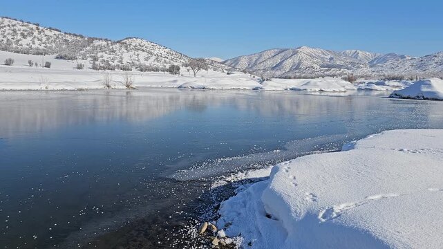 A frozen lake reflects snowy hills and distant mountains under a clear sky, capturing the serene beauty of untouched winter nature.
📍Marivan, Kurdistan 