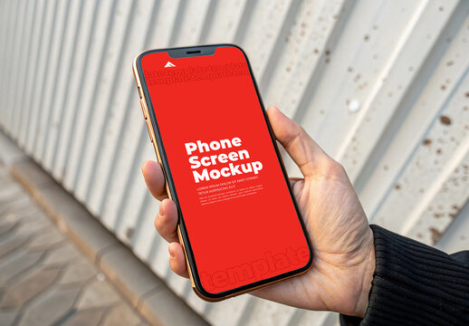Hand Holding Smartphone Screen Mockup Against Industrial Background