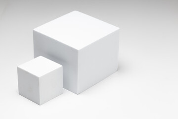 Fototapeta premium Small and large white boxes placed sideways on a white background