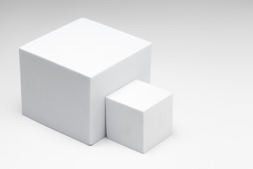 Fototapeta premium Small and large white boxes placed sideways on a white background