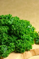 Obraz premium Fresh Kale vegetables, winterbor , curly kale , scots kale, borecole, or brasica oleracea on brown background. Super food, healthy life style concept, organic vegetable.