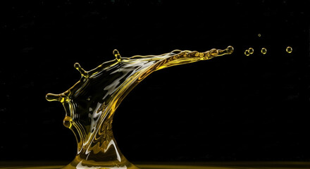 Olive oil splash texture on dark background, high contrast