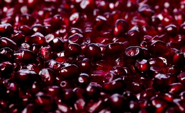 Pomegranate seeds macro texture background. Red ruby pomegranate arils close up texture. Pomegranate arils texture. Pomegranate seeds detail for texture.