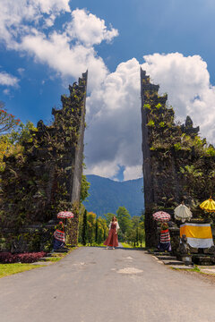 Young Woman Standing at Handara Gate, Iconic Balinese Split Gate in Bali, Indonesia