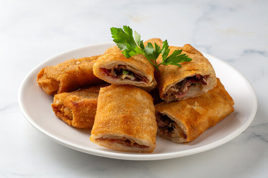 Turkish Pacanga Boregi with pastirma (pastrami) and cheddar (melted) cheese. - Pastirmali Borek