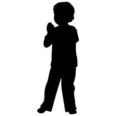 Silhouette of a young boy standing with hands clasped.