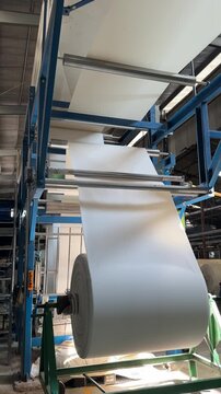Close-up of fabric rollers in textile mercerizing machine operation