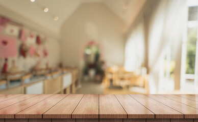 Empty wooden table top with lights bokeh on blur restaurant background.