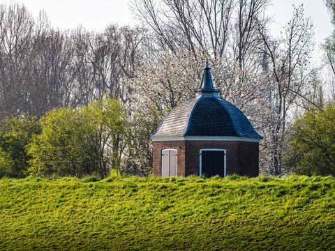 Small brick capstan house on a grassy dike