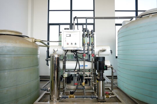 Industrial water treatment facility featuring dual storage tanks and integrated equipment system